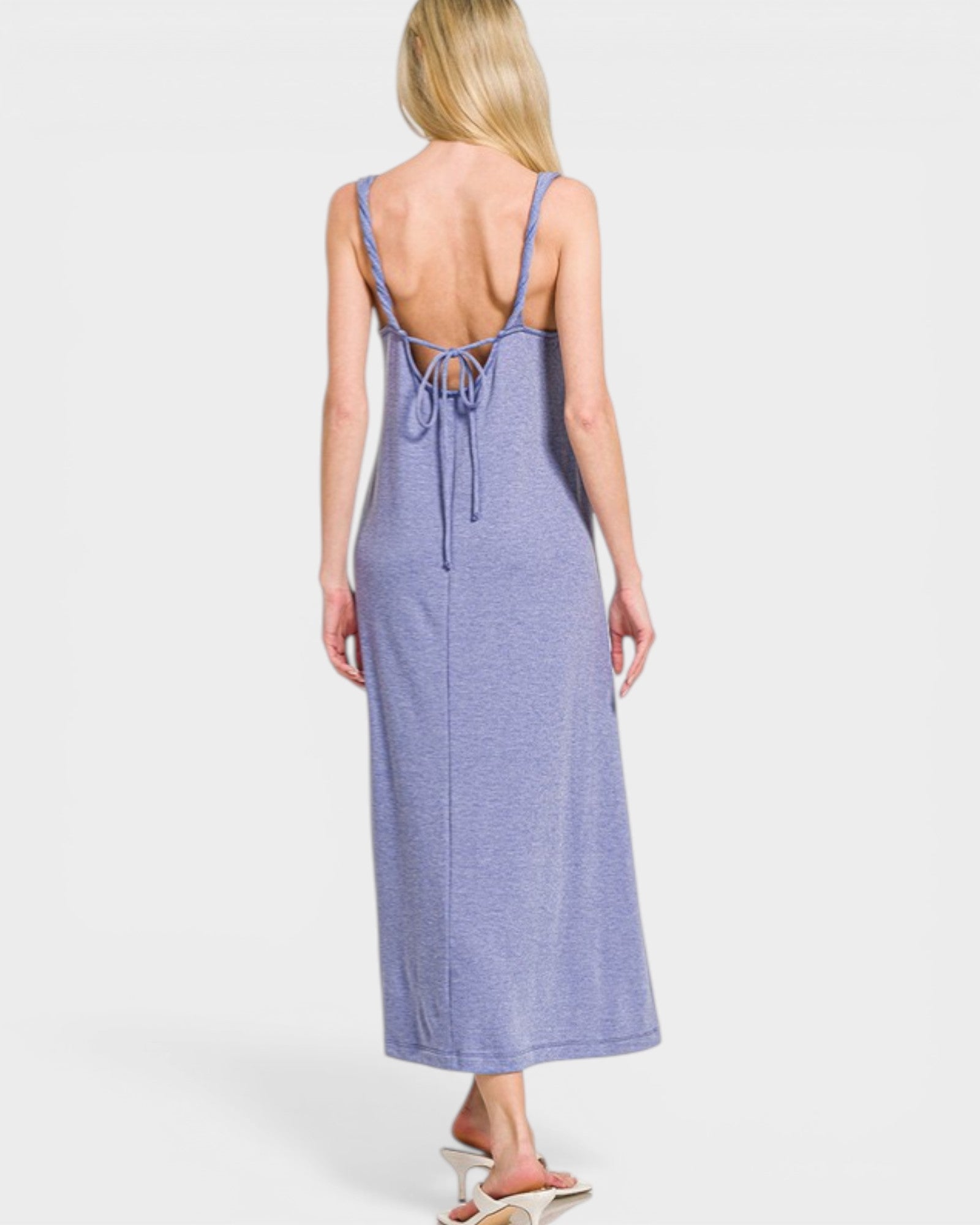 Woman wearing a purple slip dress on a white background