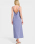 Woman wearing a purple slip dress on a white background