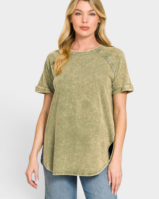 Woman wearing a green t-shirt with rolled-up sleeves on a white background