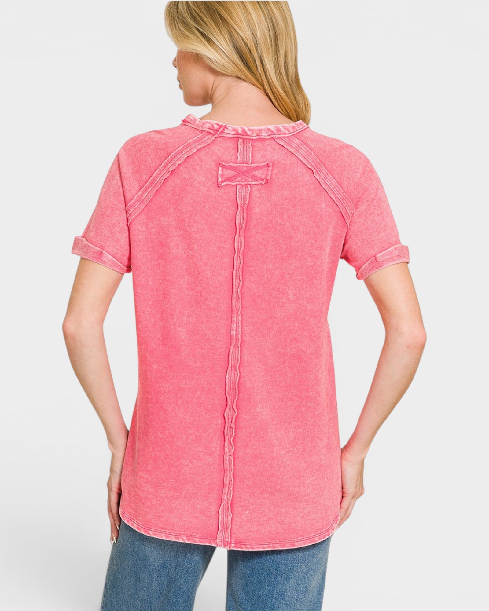 Woman wearing a pink short-sleeve shirt on a white background