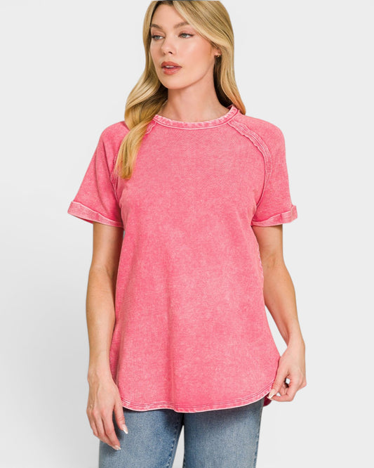 Woman wearing a pink t-shirt against a white background