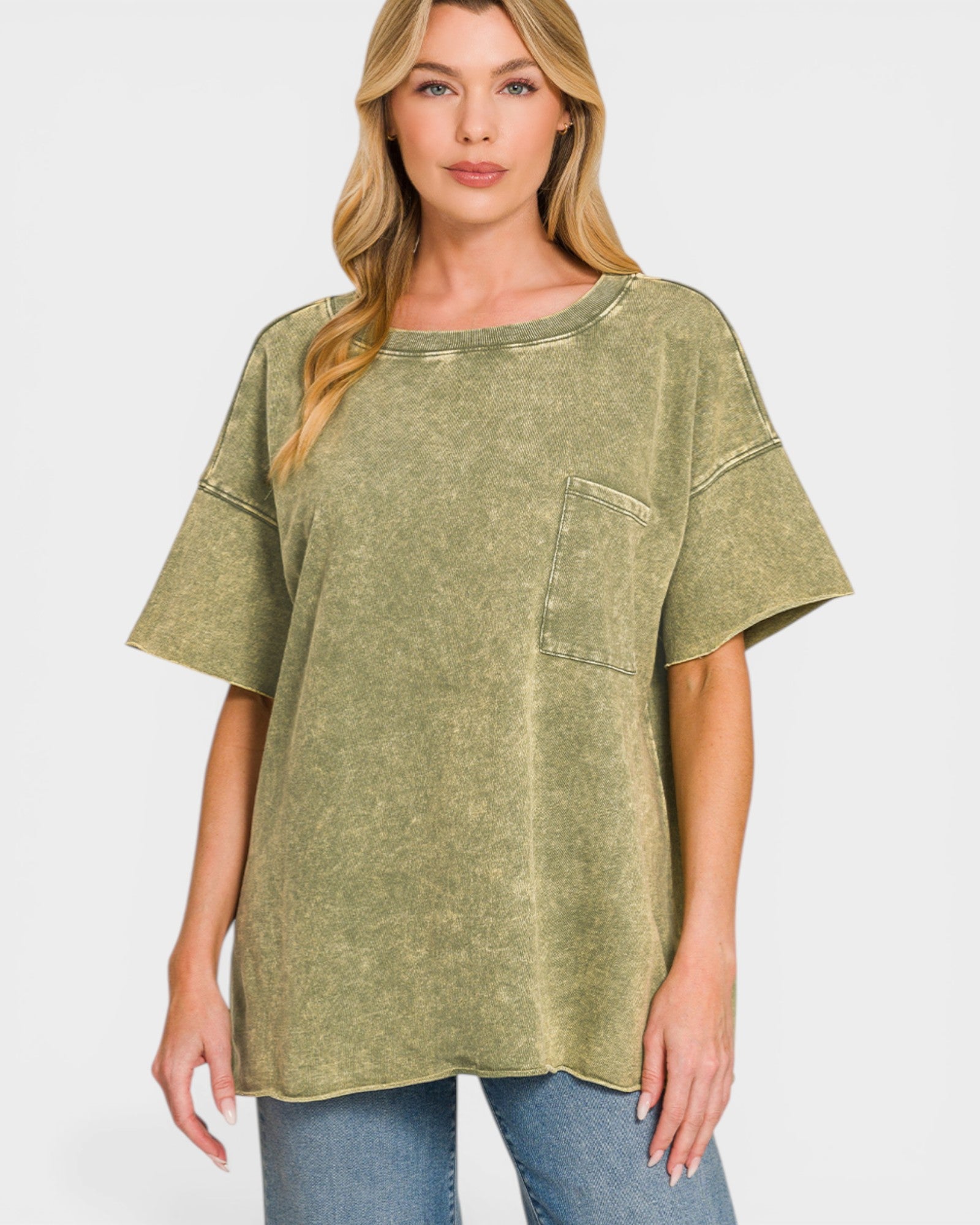 Woman wearing a green oversized t-shirt with a pocket on a white background