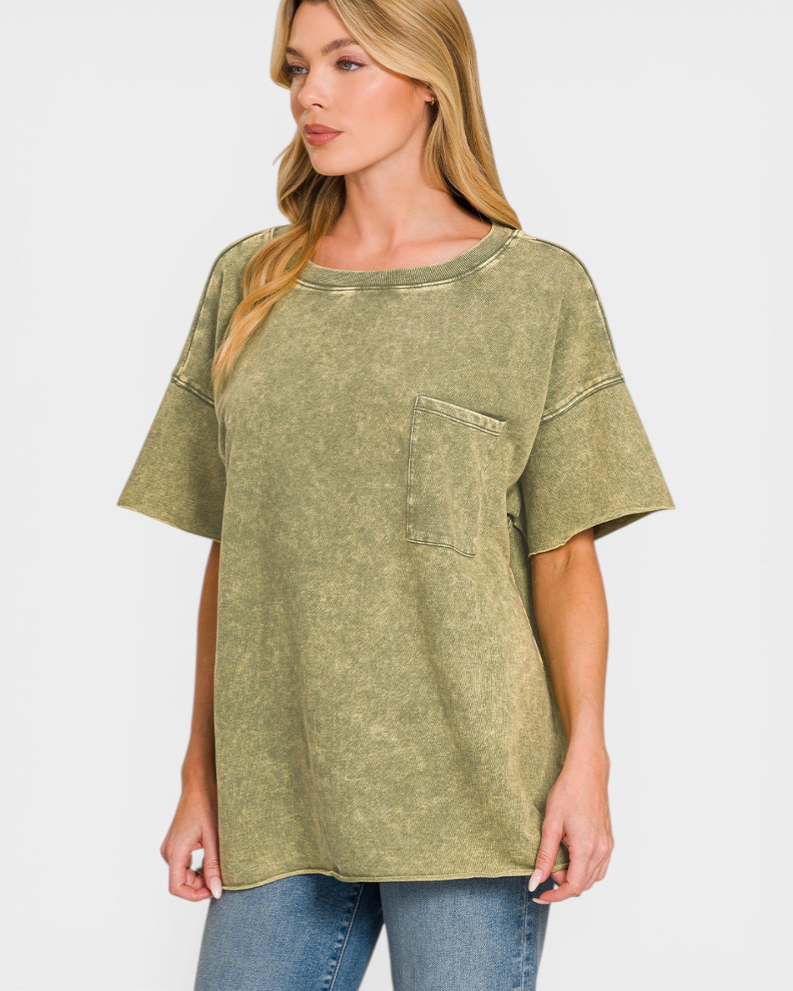 Woman wearing a green oversized t-shirt with a pocket on a white background