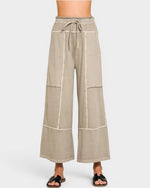Beige wide-leg pants with a tie waist on a white background