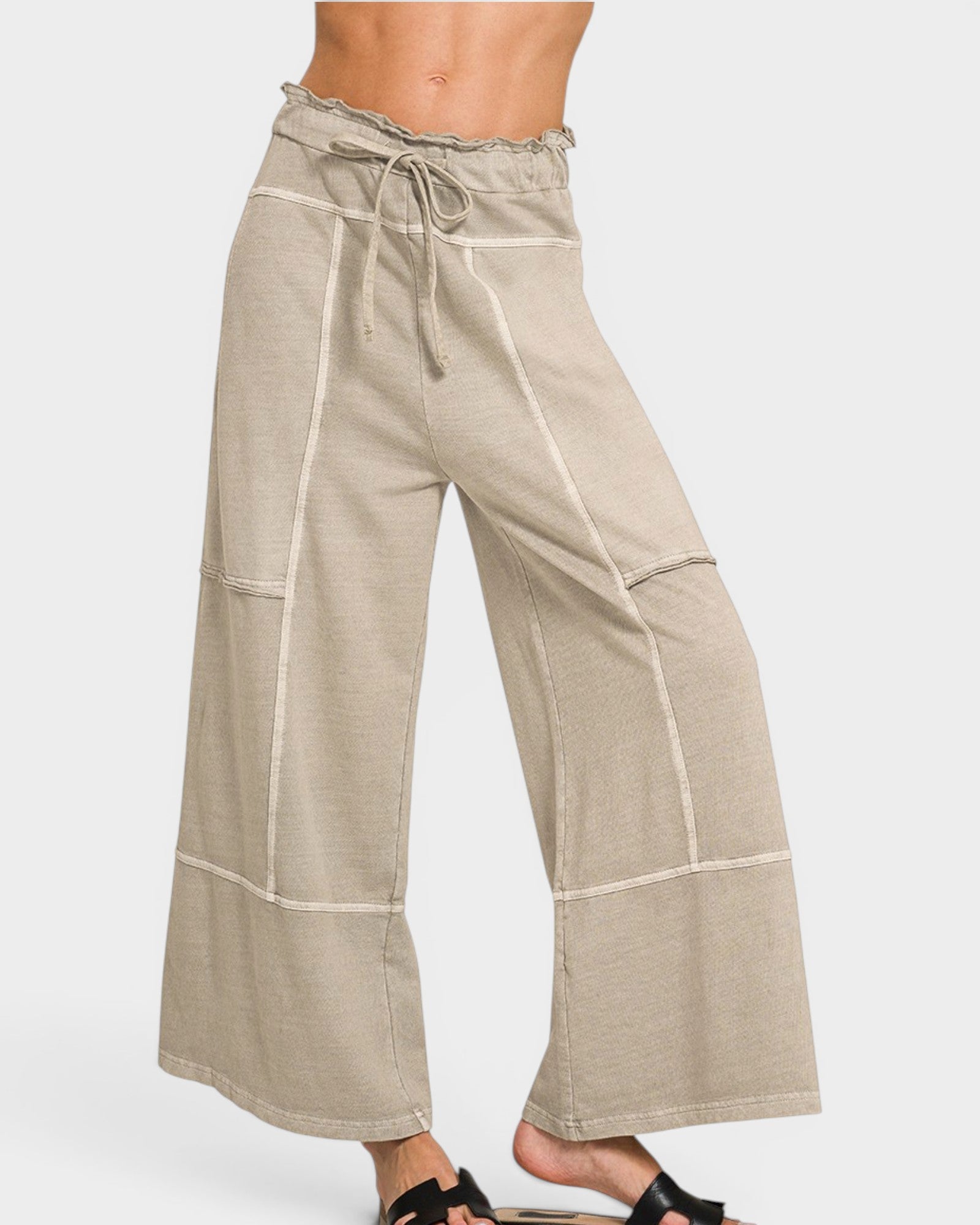 Beige wide-leg pants with white stripes on a white background