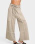 Beige wide-leg pants with white stripes on a white background