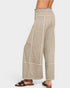 Beige wide-leg pants worn by a person on a white background