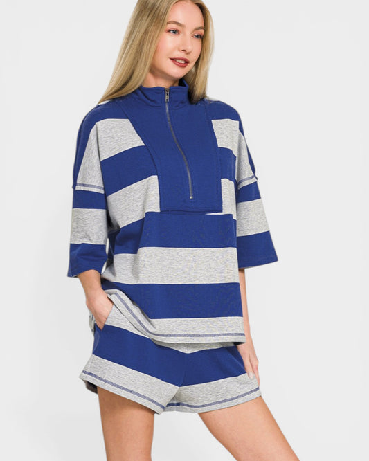 Woman wearing a blue and gray striped outfit on a white background