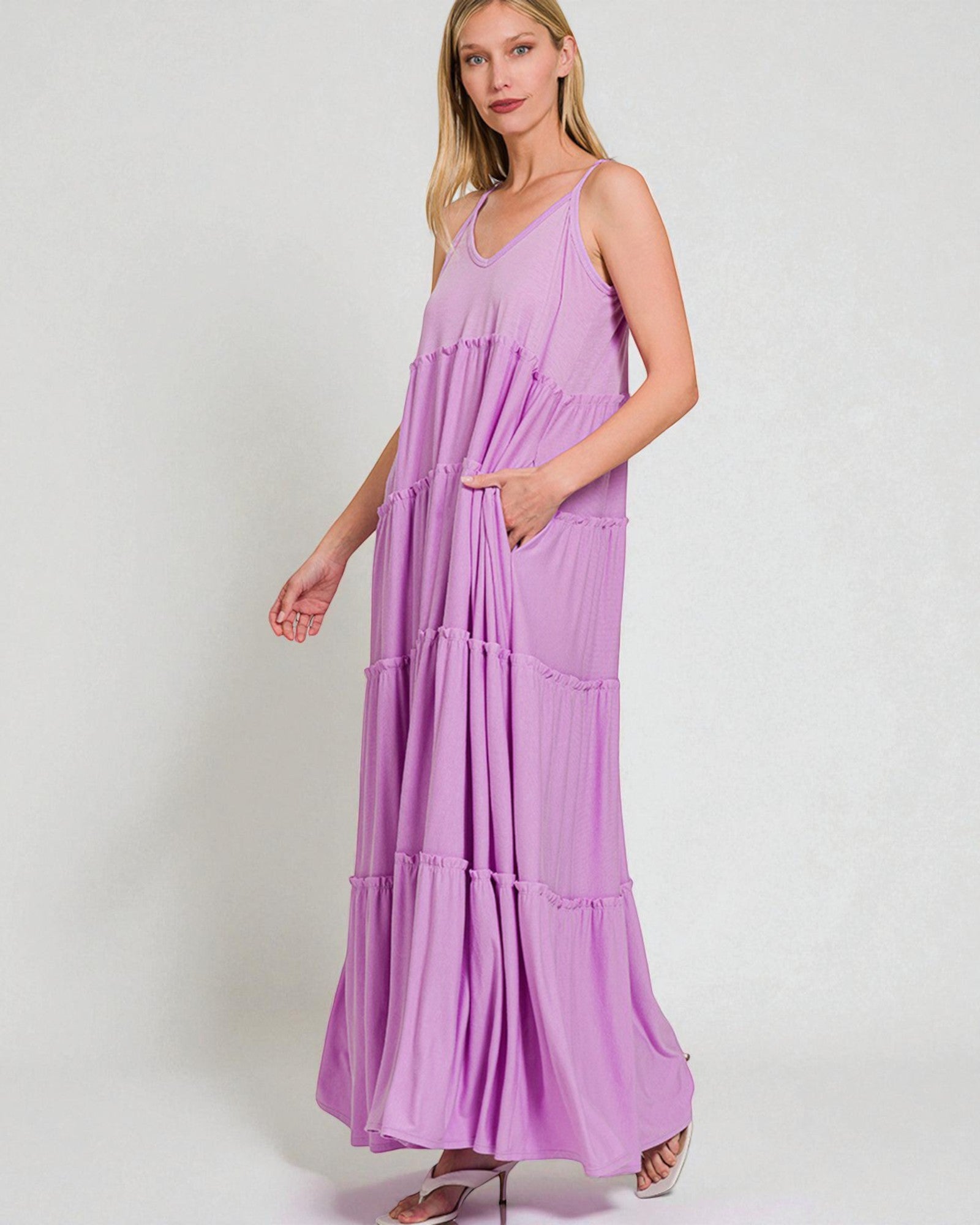 Woman wearing a purple maxi dress on a white background