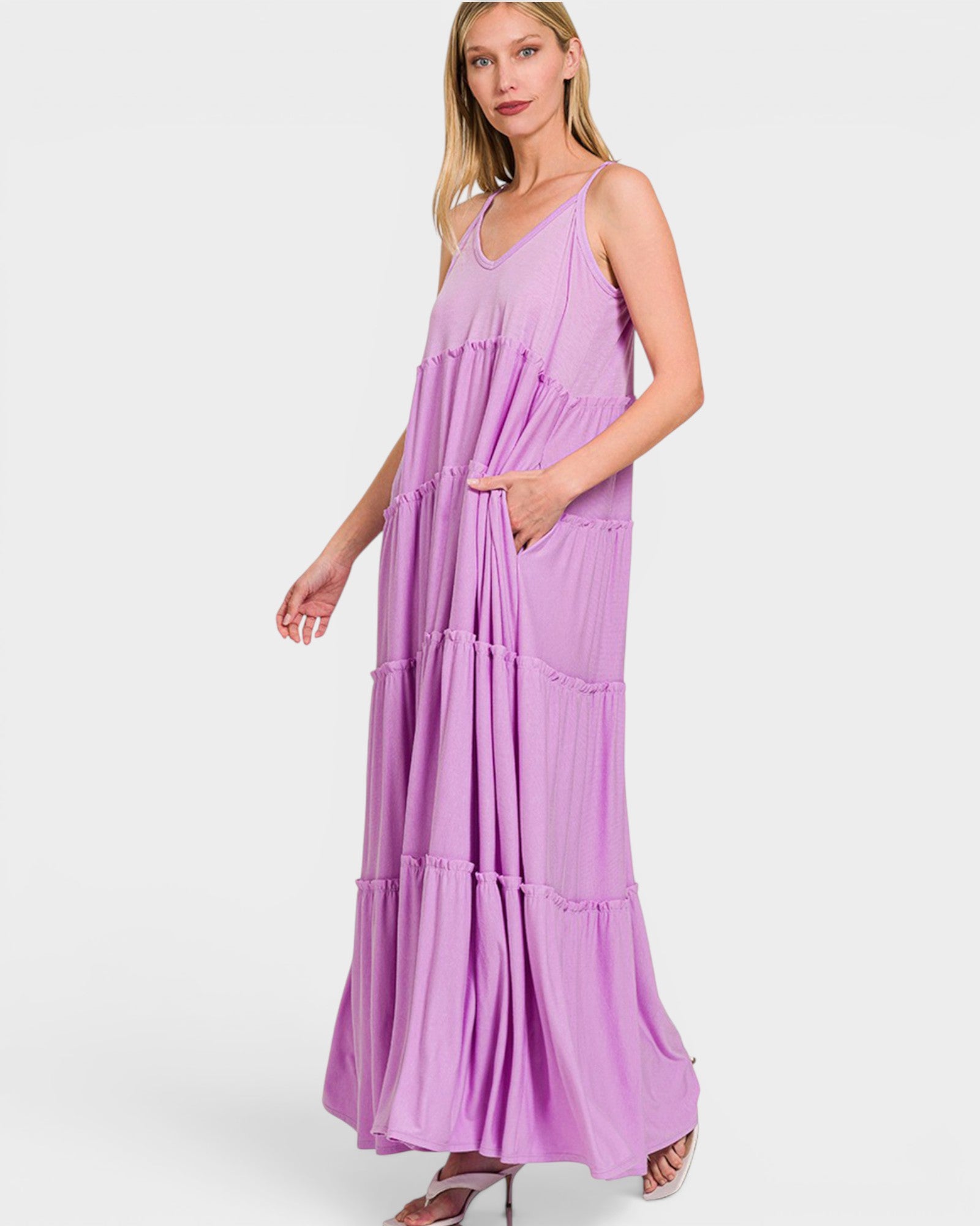 Woman wearing a purple maxi dress on a white background
