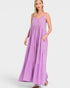 Woman wearing a purple maxi dress on a white background