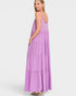 Woman wearing a purple tiered dress on a white background