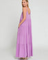 Woman wearing a purple tiered dress on a white background