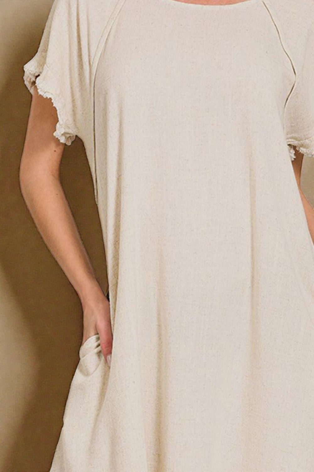 Beige dress with short sleeves and a plain background