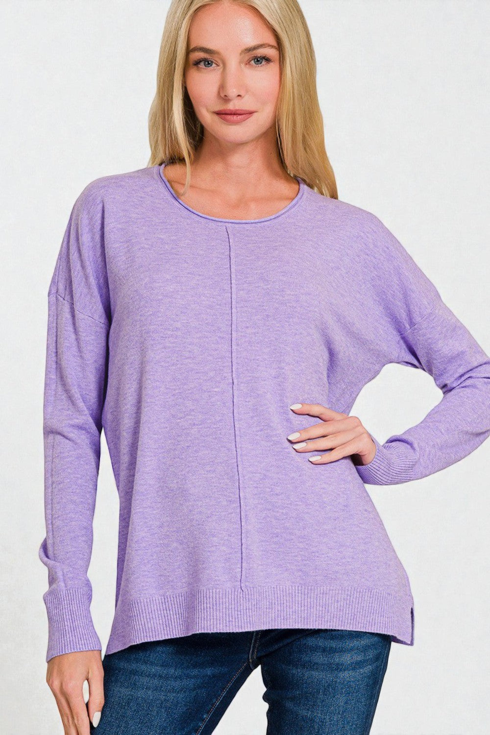Woman wearing a purple sweater against a white background