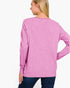 A woman shown from the back wearing a heather pink long-sleeve knit top and dark blue jeans against a plain white background.