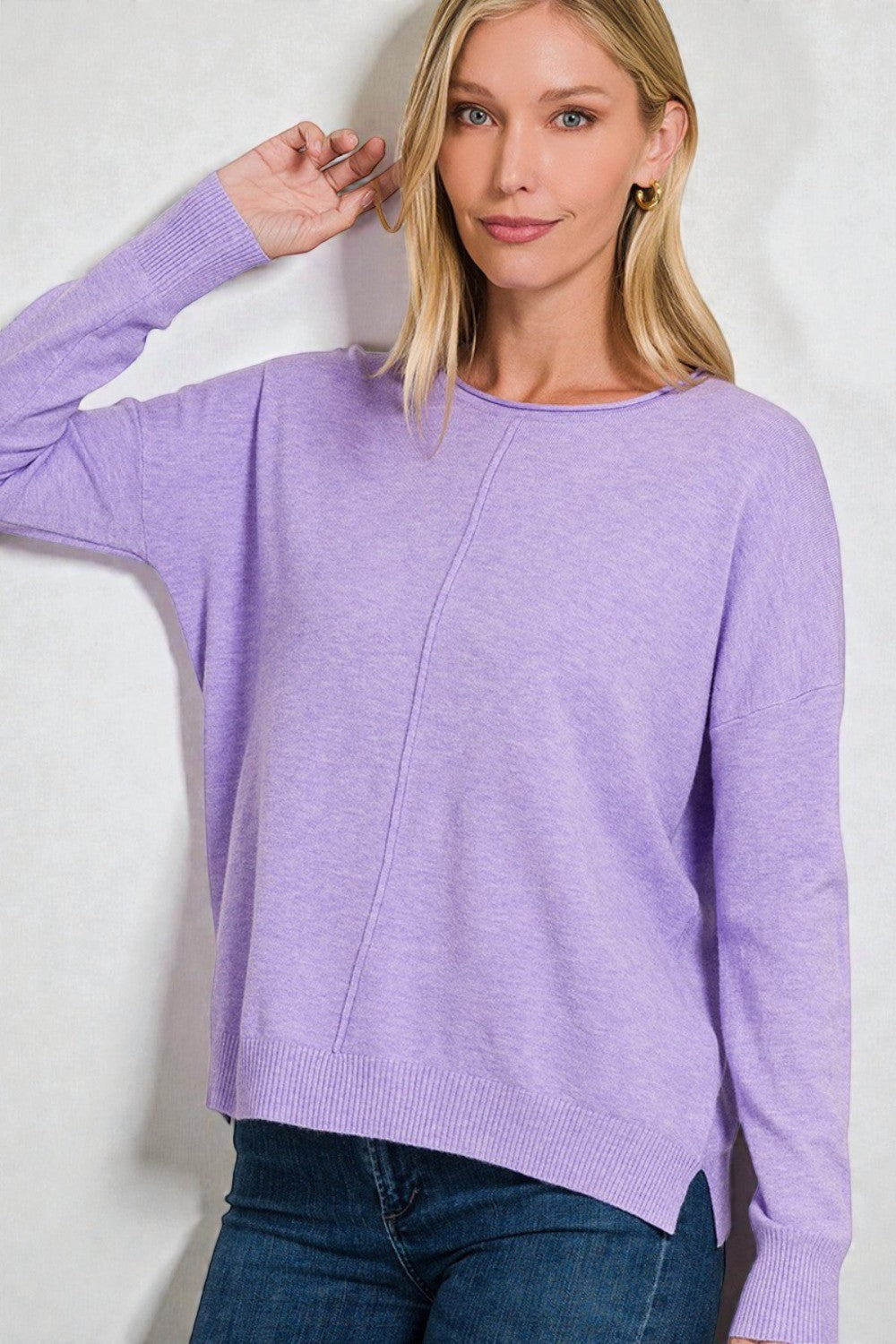Woman wearing a purple sweater against a white background