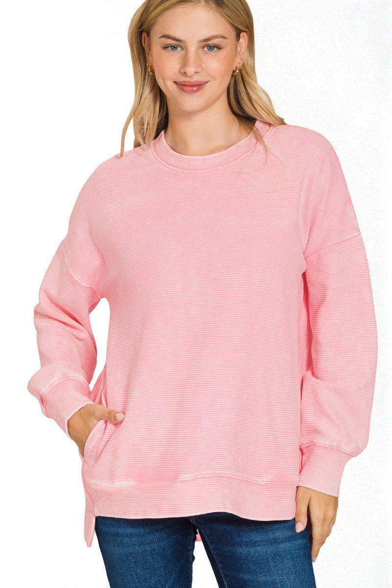 Woman wearing a pink sweatshirt on a white background