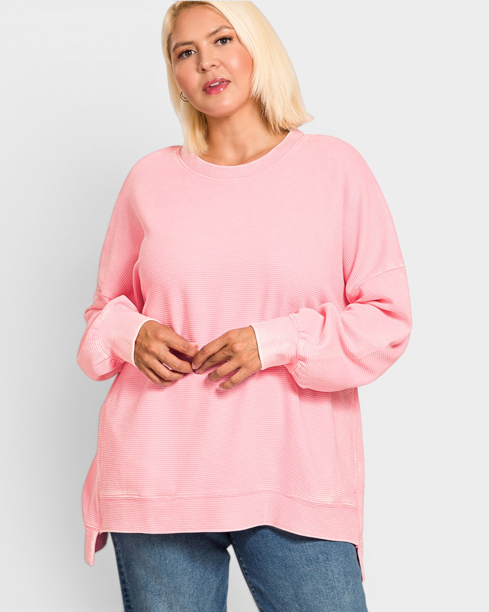 Woman wearing a pink sweatshirt on a white background