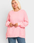 Woman wearing a pink sweatshirt on a white background