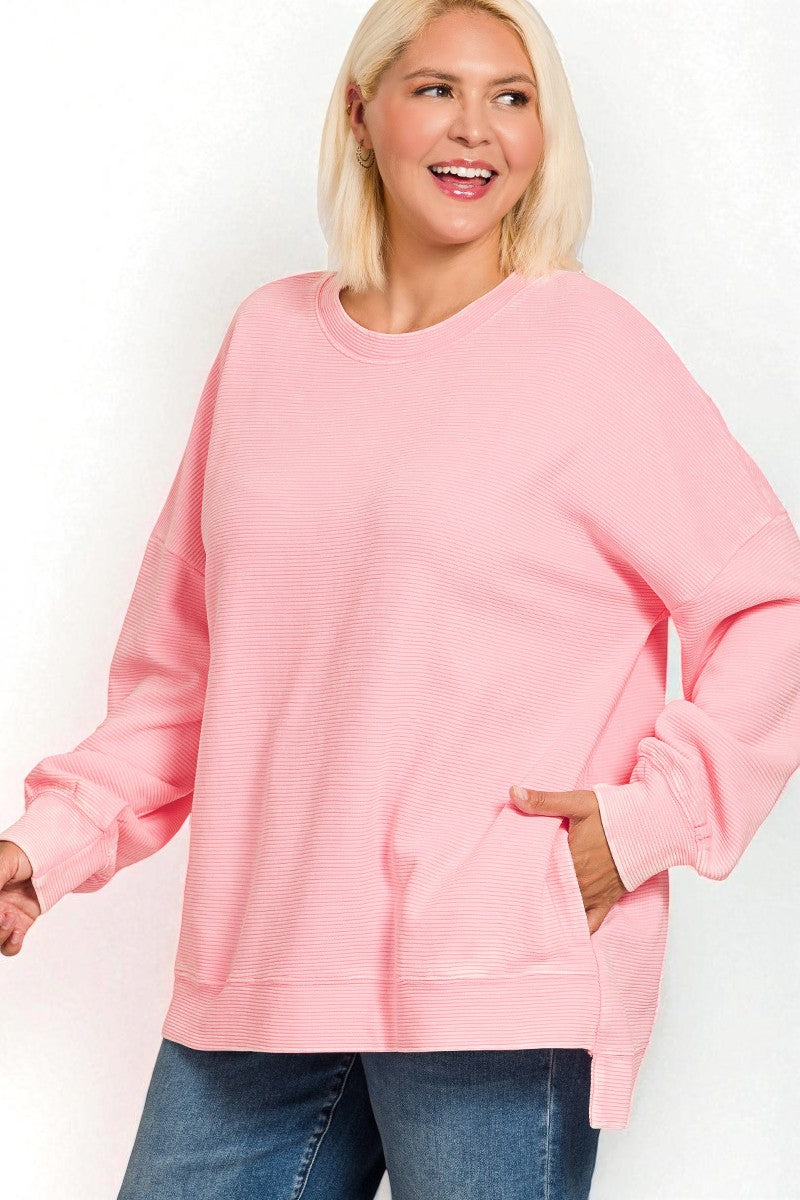 Woman wearing a pink sweater and blue jeans on a white background