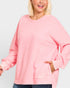 Person wearing a pink sweatshirt against a plain background