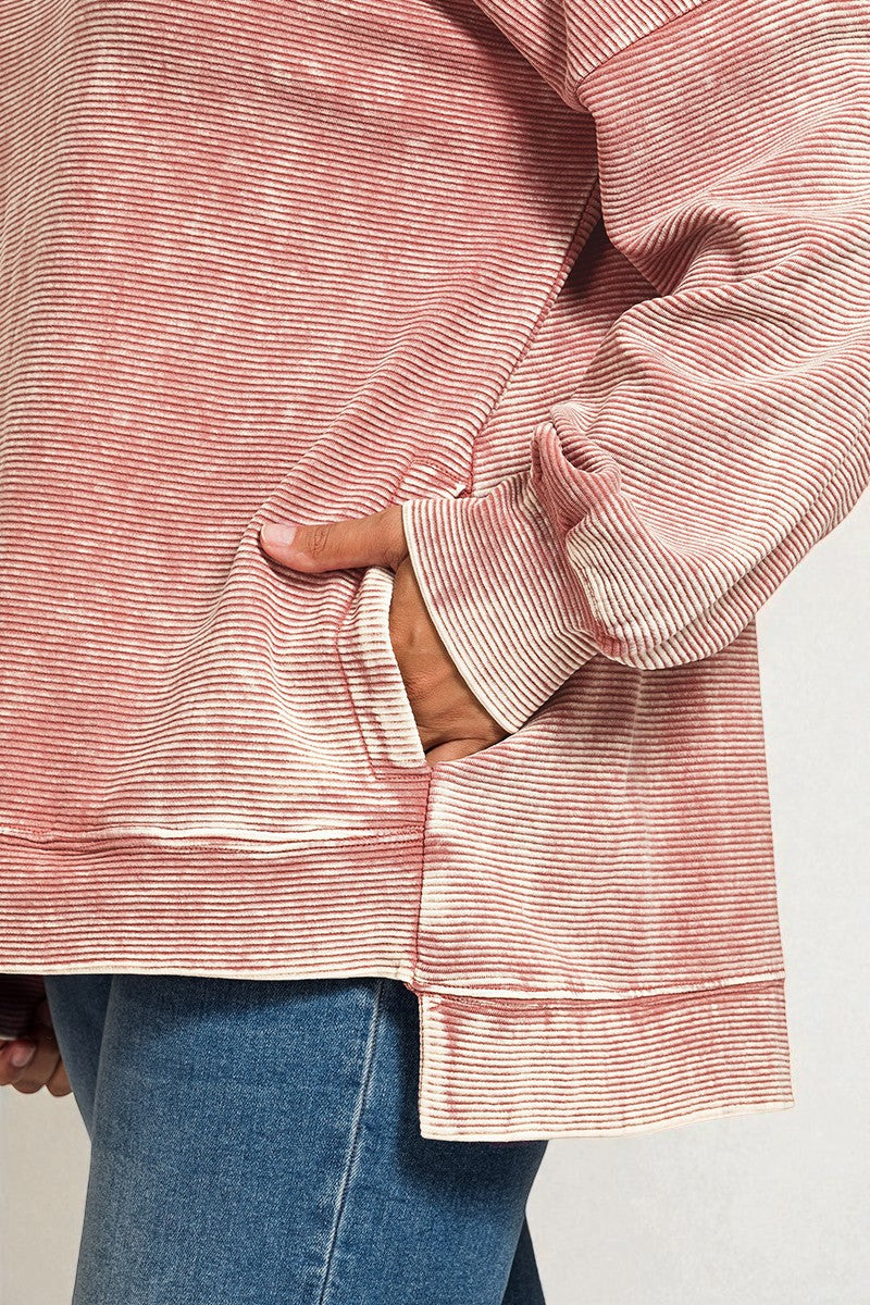 Close-up of a person wearing a pink striped shirt with a white background