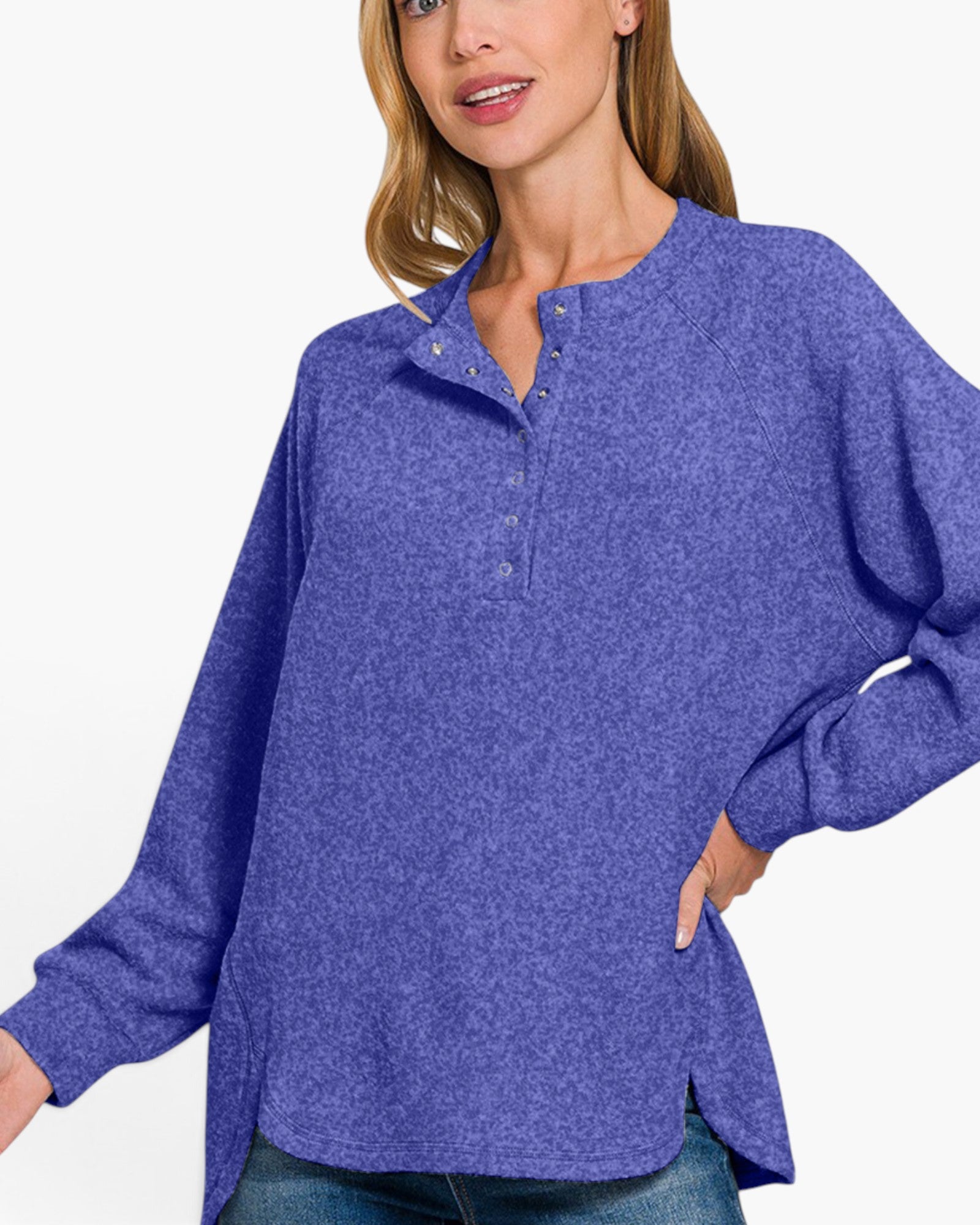 A woman wearing a heathered periwinkle blue long-sleeve henley top with a buttoned collar, shown against a plain white background.