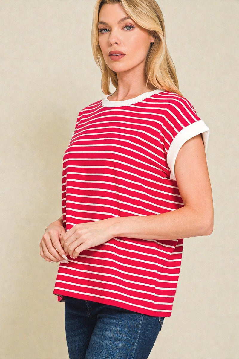 Woman wearing a red and white striped shirt against a beige background