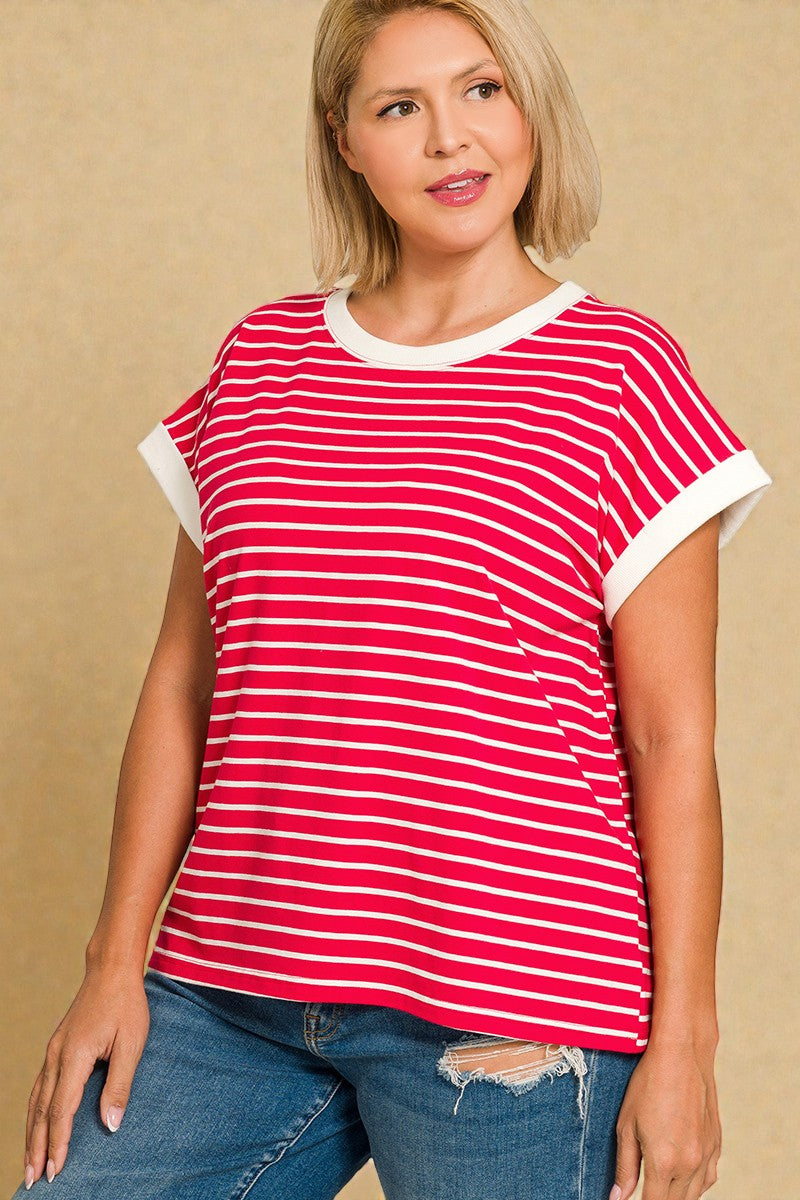 Woman wearing a red and white striped shirt with blue jeans on a beige background