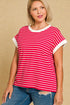 Woman wearing a red and white striped shirt with blue jeans on a beige background