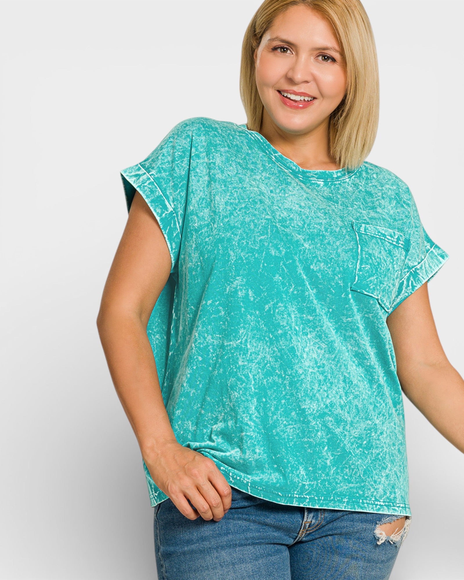 Woman wearing a teal acid-wash t-shirt on a white background