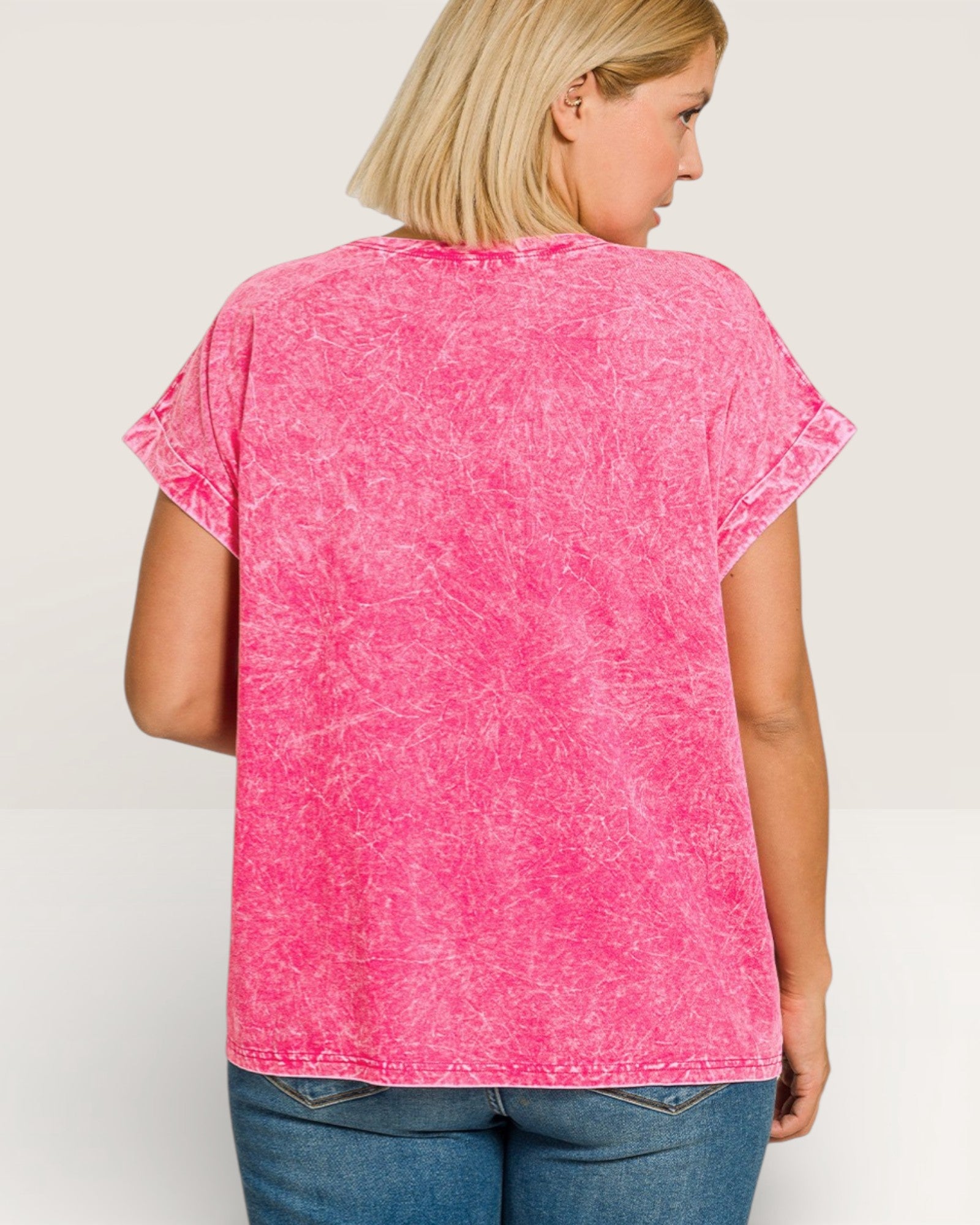 Person wearing a pink t-shirt with a white background