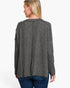 A woman shown from the back wearing a dark gray heathered knit long-sleeve top and blue jeans against a plain white background.