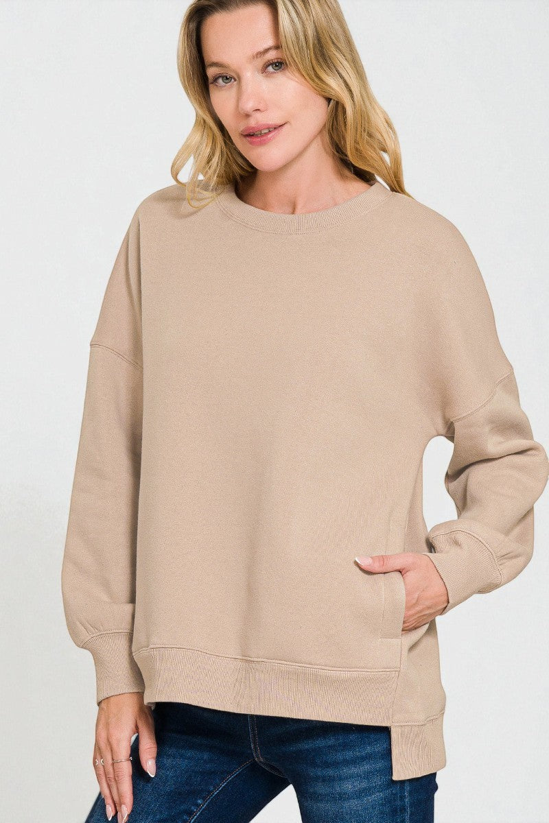 Woman wearing a beige sweatshirt on a white background