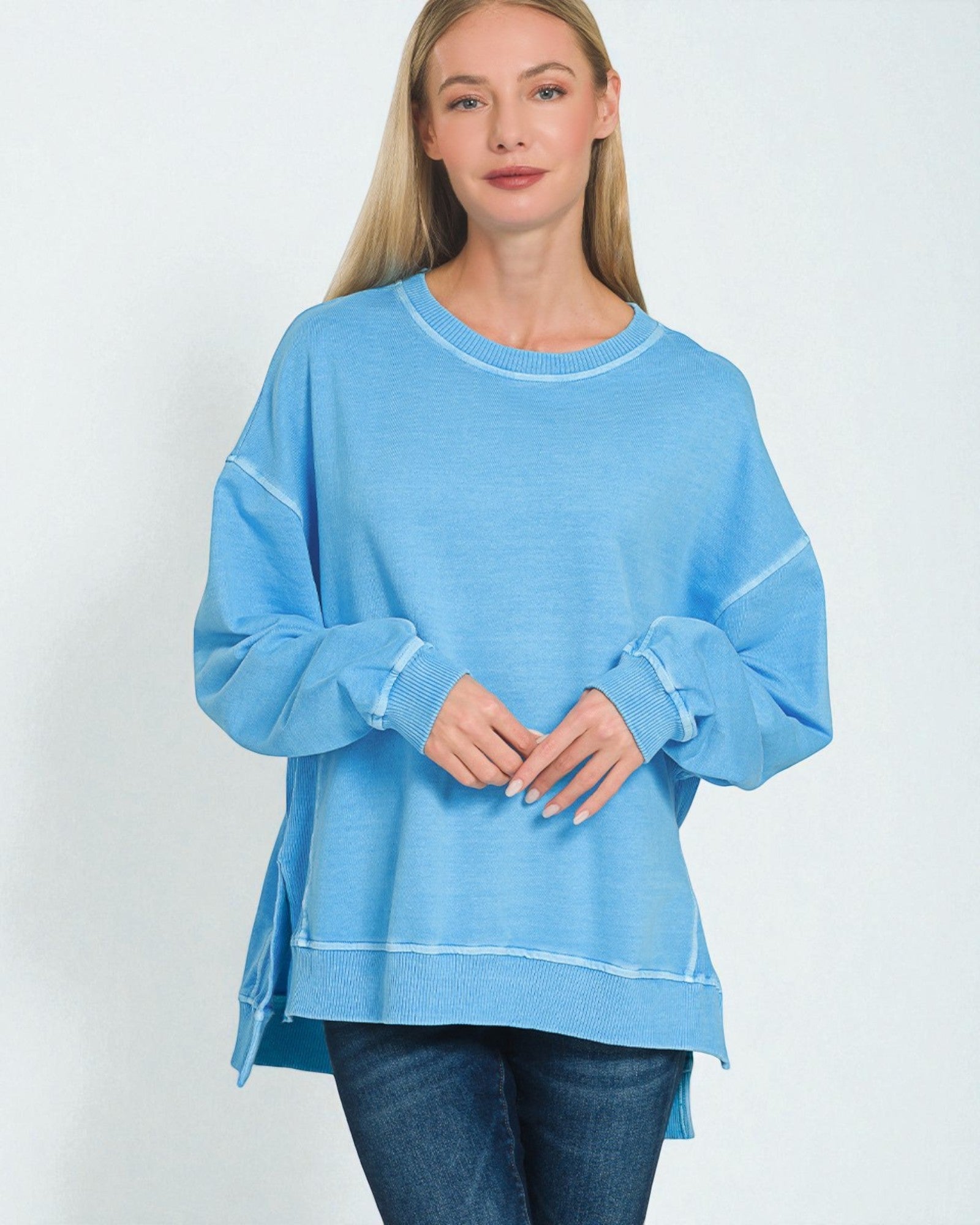 Woman wearing a light blue sweatshirt on a white background