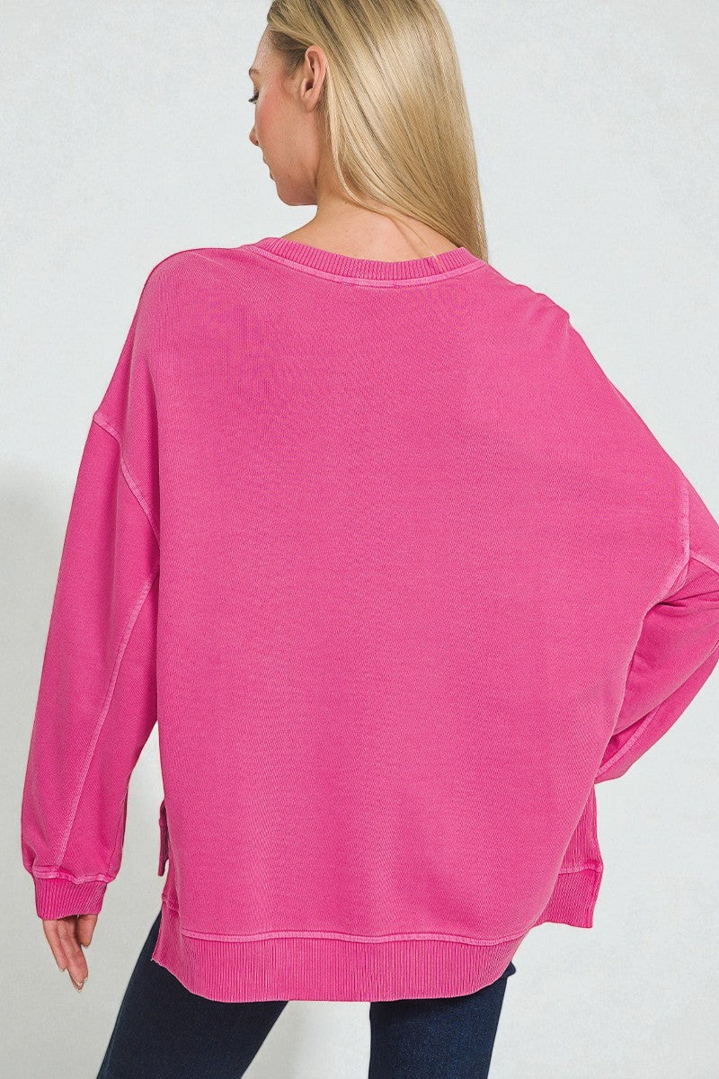Person wearing a pink sweatshirt on a plain background