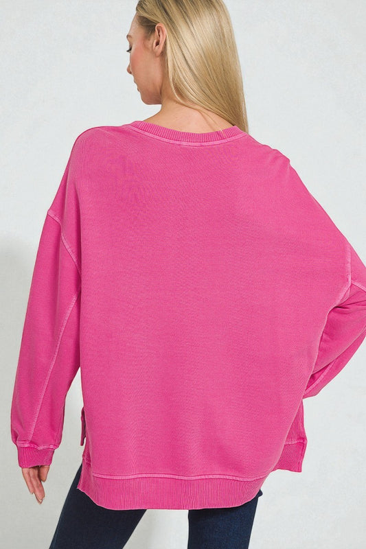 Person wearing a pink sweatshirt on a plain background