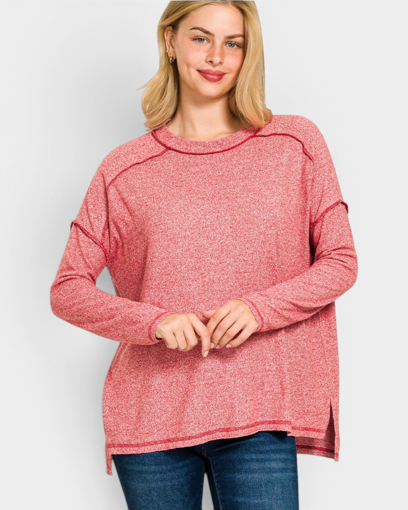 Woman wearing a pink long-sleeve top on a white background