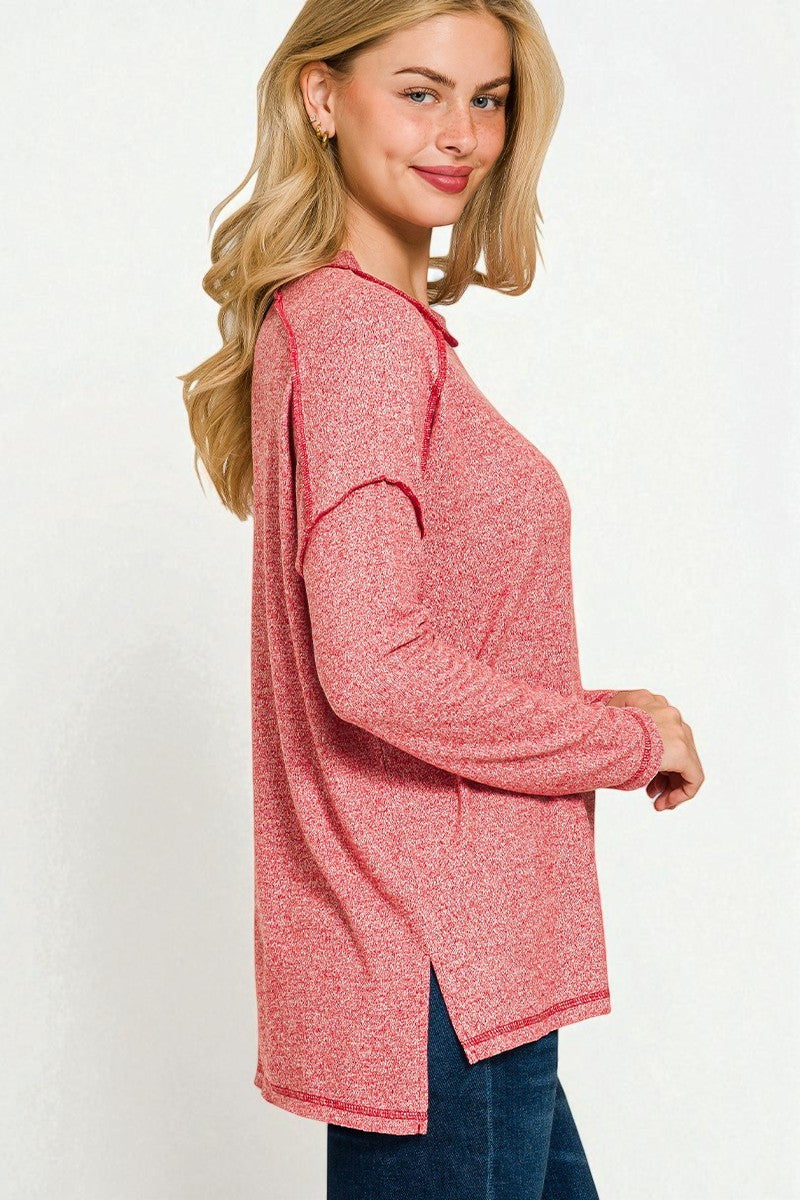 Woman wearing a pink long-sleeve top on a white background