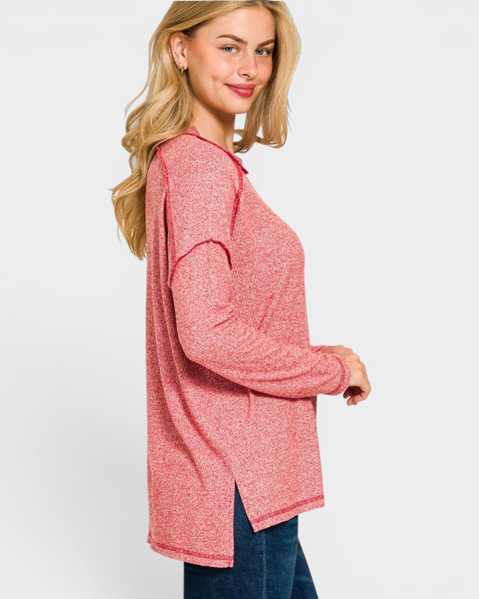 Woman wearing a pink long-sleeve top on a white background