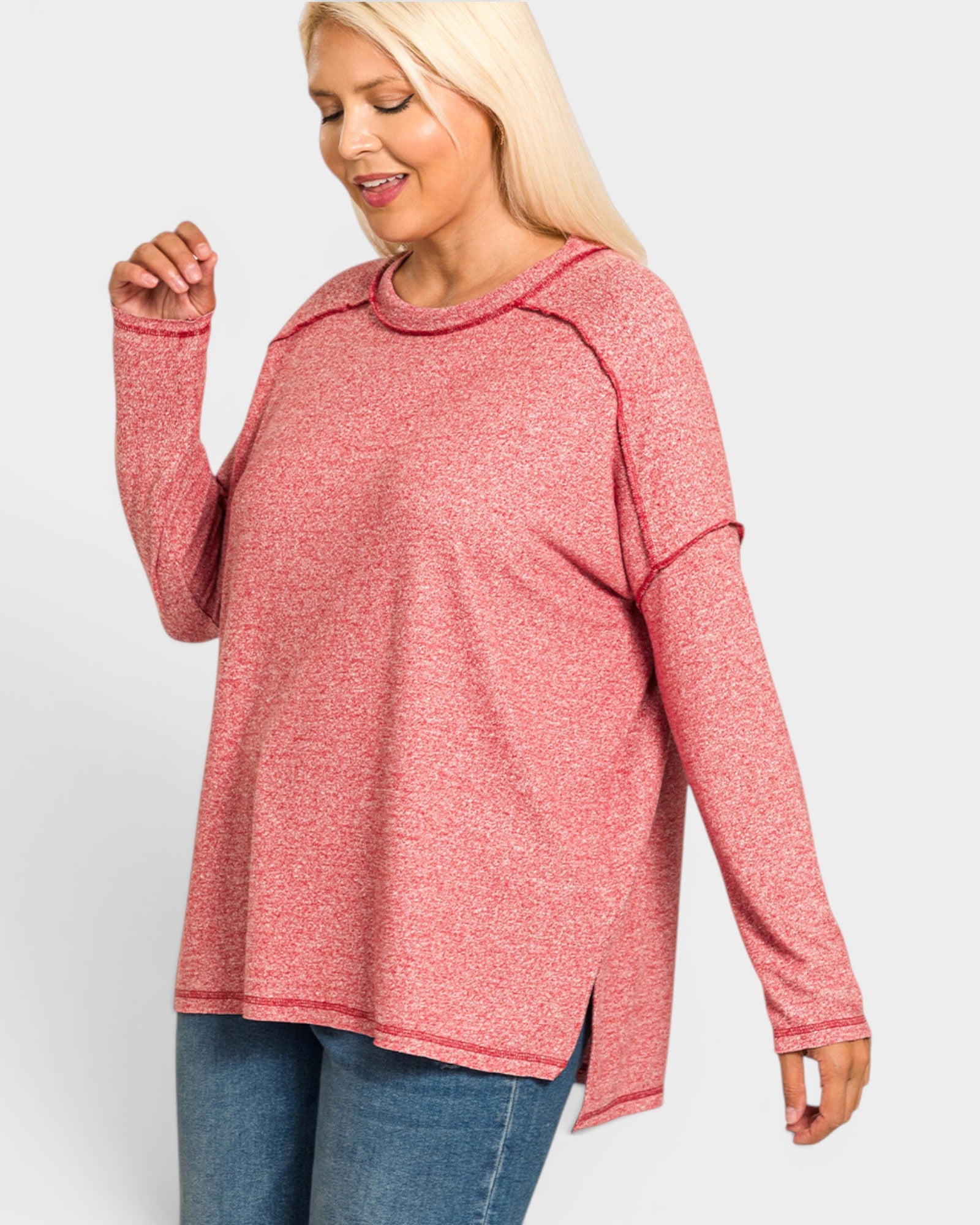 Woman wearing a pink long-sleeve top on a white background