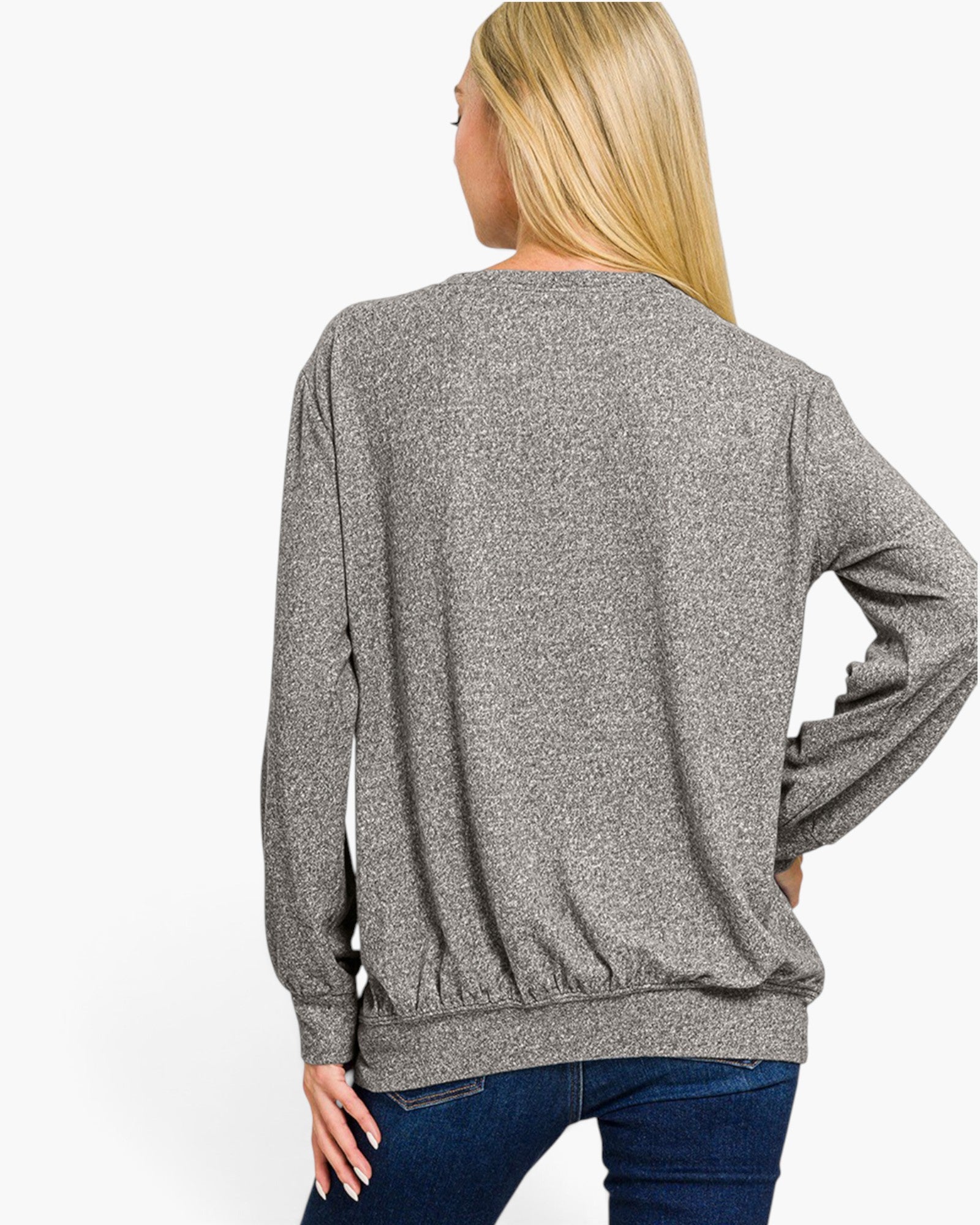 A woman shown from the back wearing a heather gray long-sleeve crewneck sweatshirt and blue jeans against a plain white studio background.