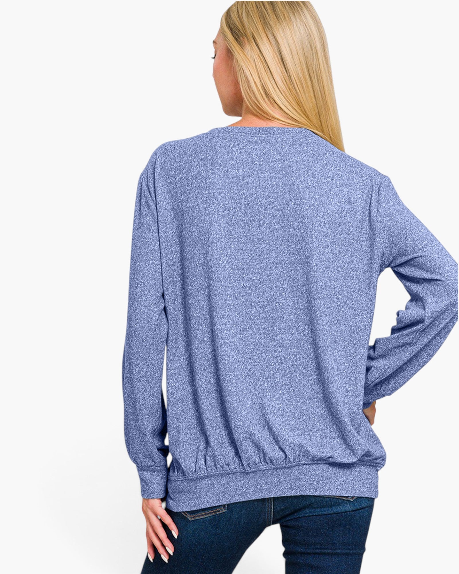 A woman shown from the back wearing a heathered blue long-sleeve crewneck sweatshirt and dark blue jeans against a plain white background.