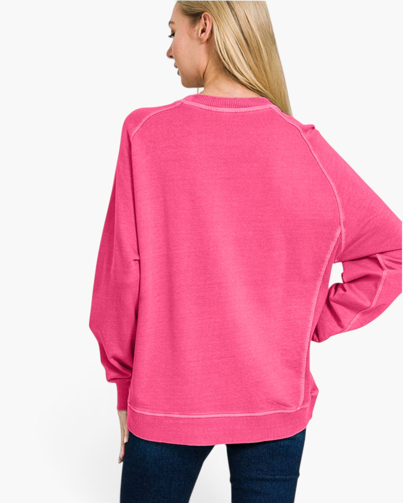 A woman wearing a bright pink long-sleeve sweatshirt, shown from the back against a plain white background.