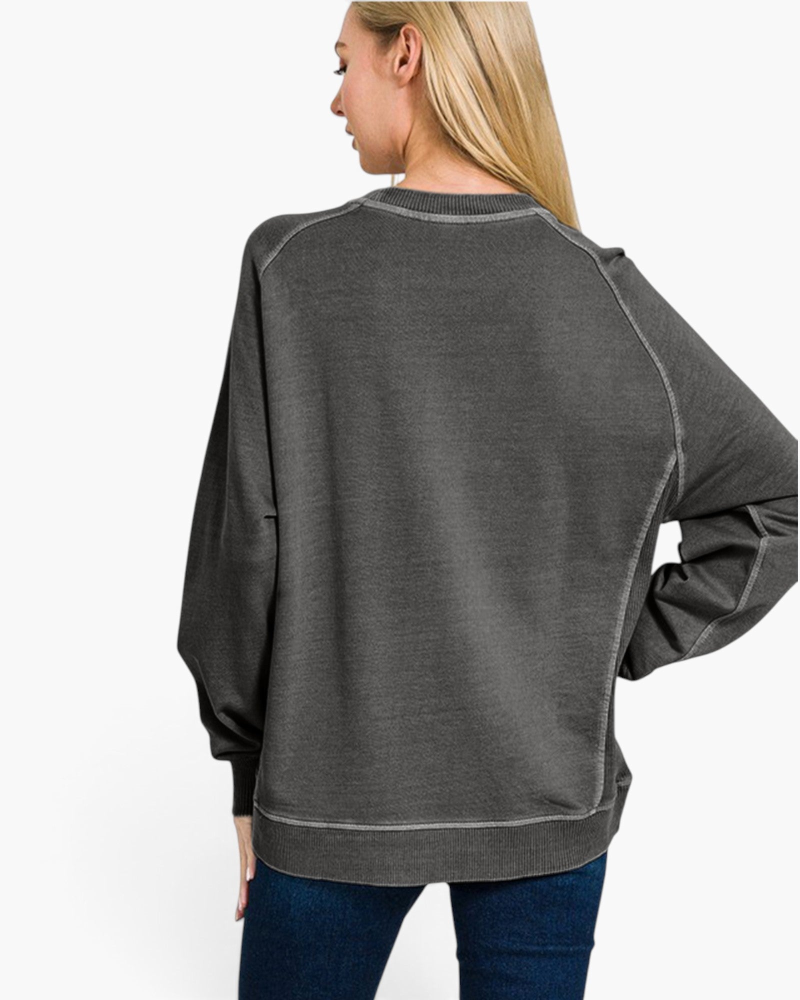 A woman shown from the back wearing a dark gray heathered crewneck sweatshirt with contrast stitching and long raglan sleeves, paired with blue jeans, against a plain white background.