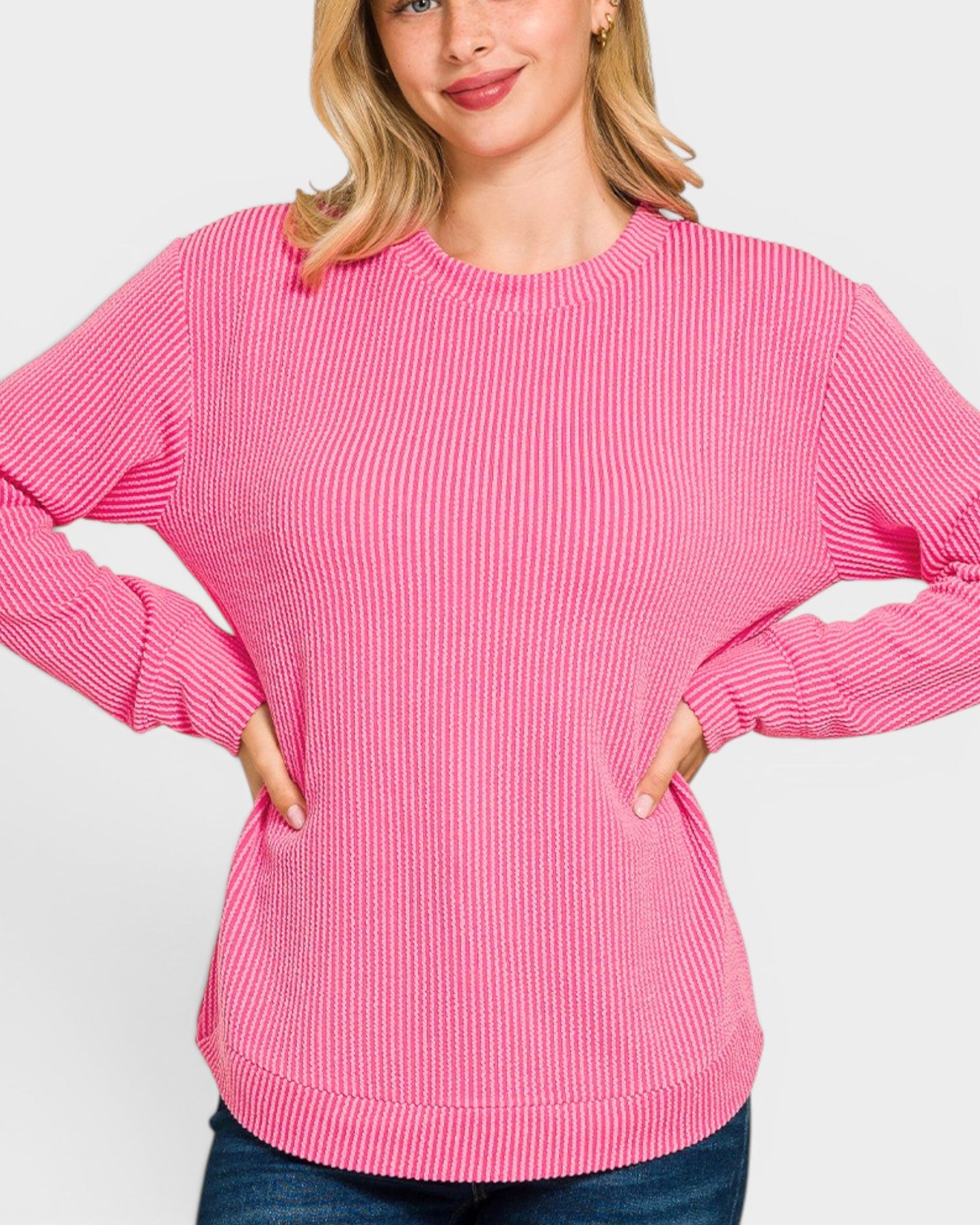 Woman wearing a pink sweater on a white background