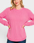 Woman wearing a pink sweater on a white background