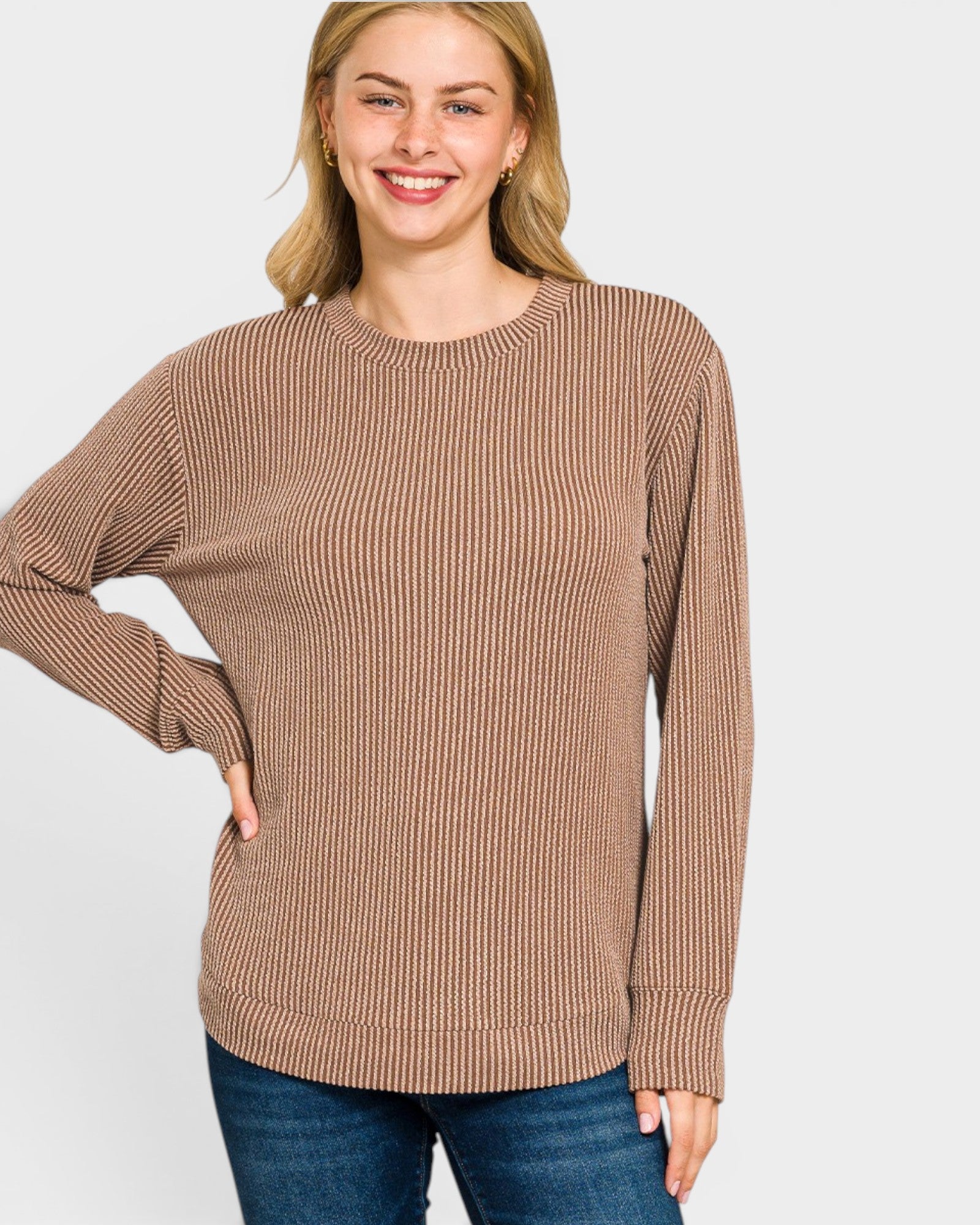 Woman wearing a brown ribbed sweater on a white background