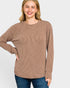 Woman wearing a brown ribbed sweater on a white background